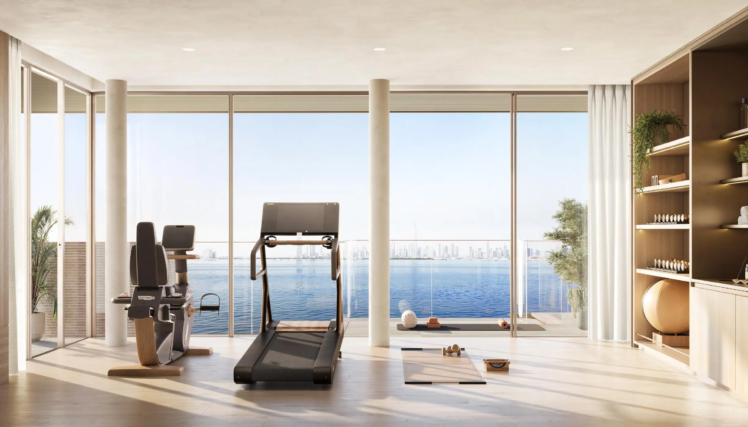 Fitness space at Solaya with floor-to-ceiling windows facing the water